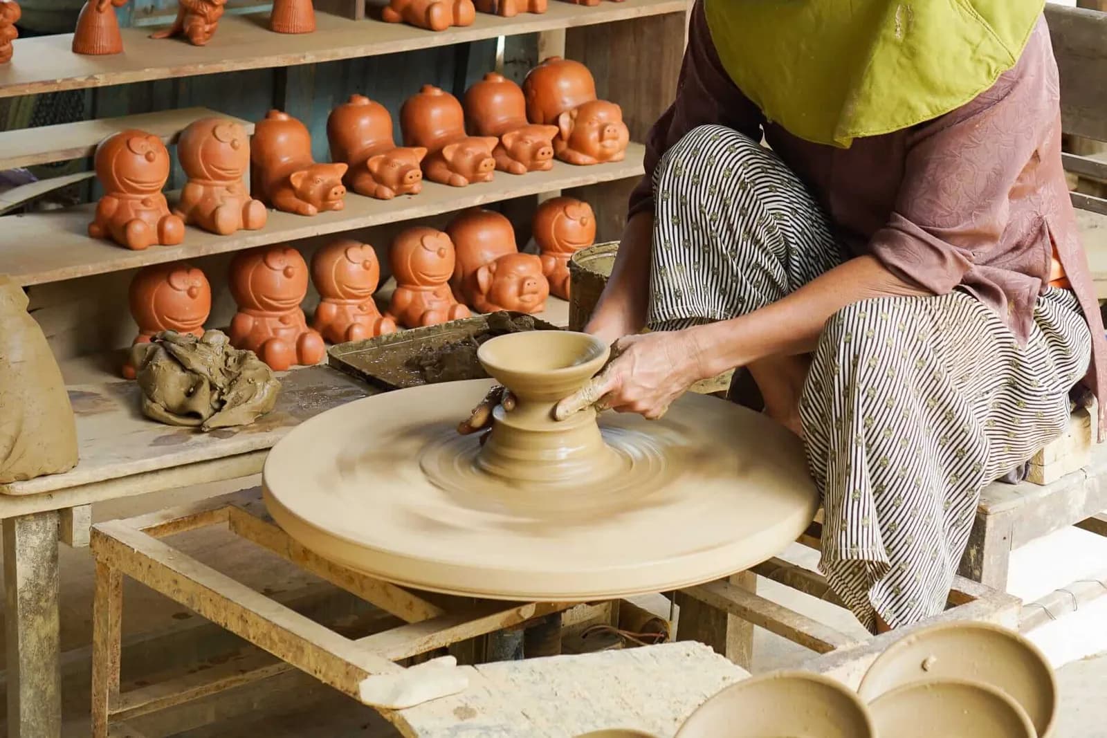 Potter shaping clay on a wheel