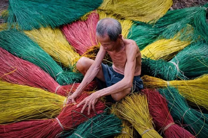 Artisan sorting colorful dyed threads