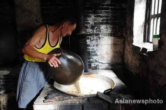 Local craftsman preparing rice wine